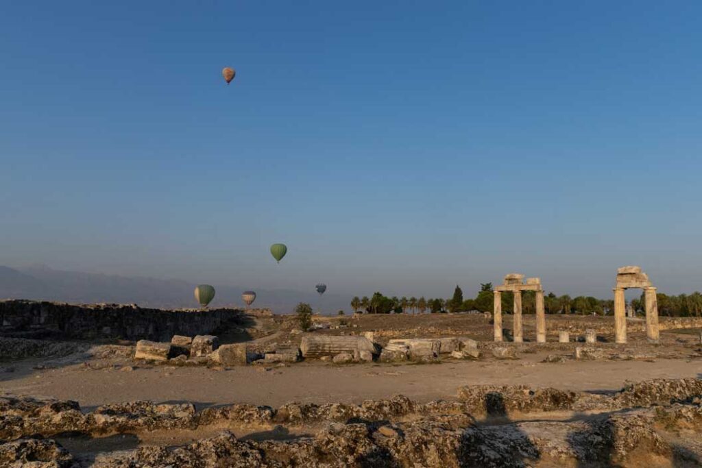 hot air balloons in Pamukkale above the ancient ruins 