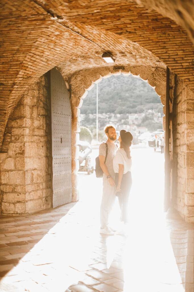 a couple posing at Sea Gate in Kotor