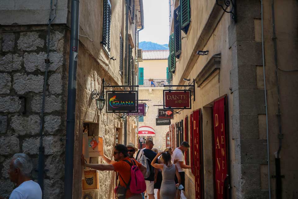 People shopping from souvenir shops in old Kotor