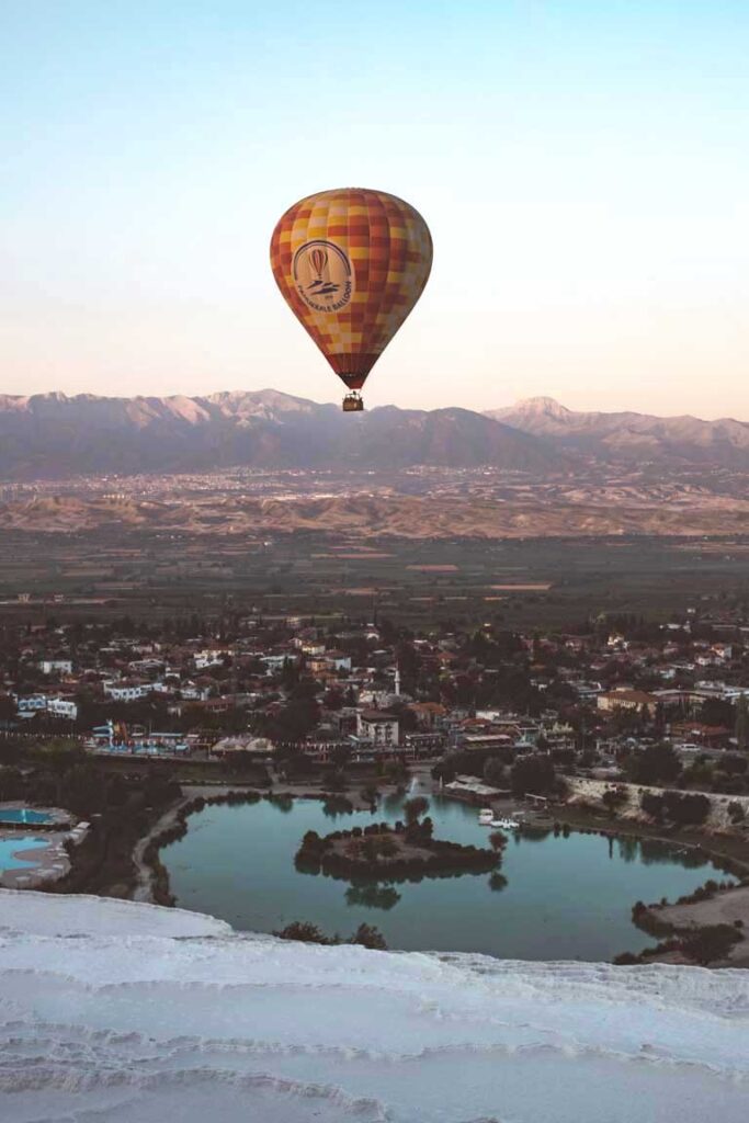 hot air balloon flying above the travertines