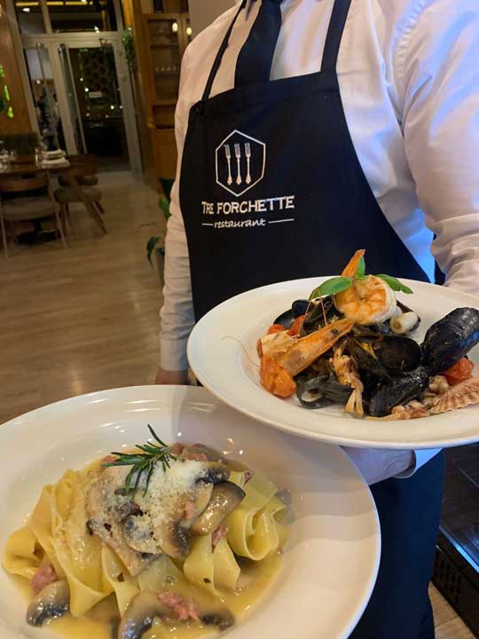 Plates with seafood and pasta from Tre Forchette Restaurant in Vlore
