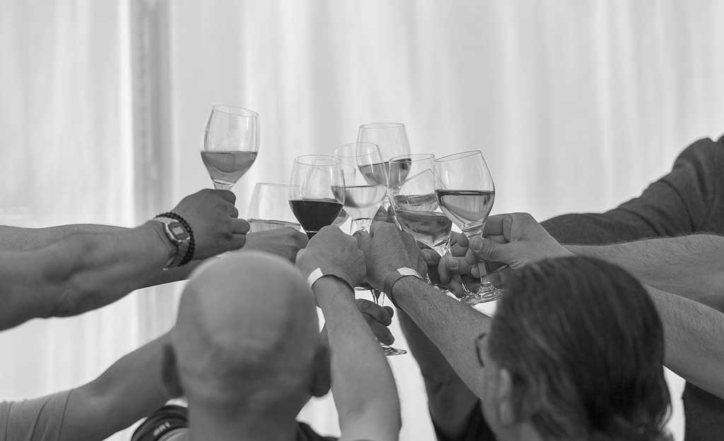 people celebrating each holding a glass of wine