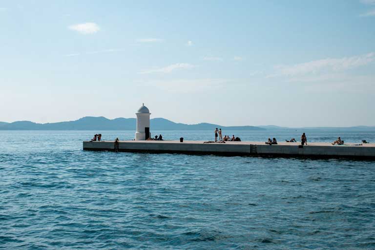 people sunbathing and hanging around Zadar's dock