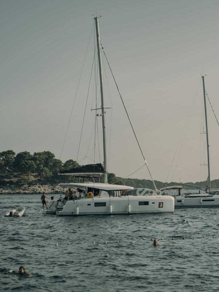 people swimming around catamarans in Hvar