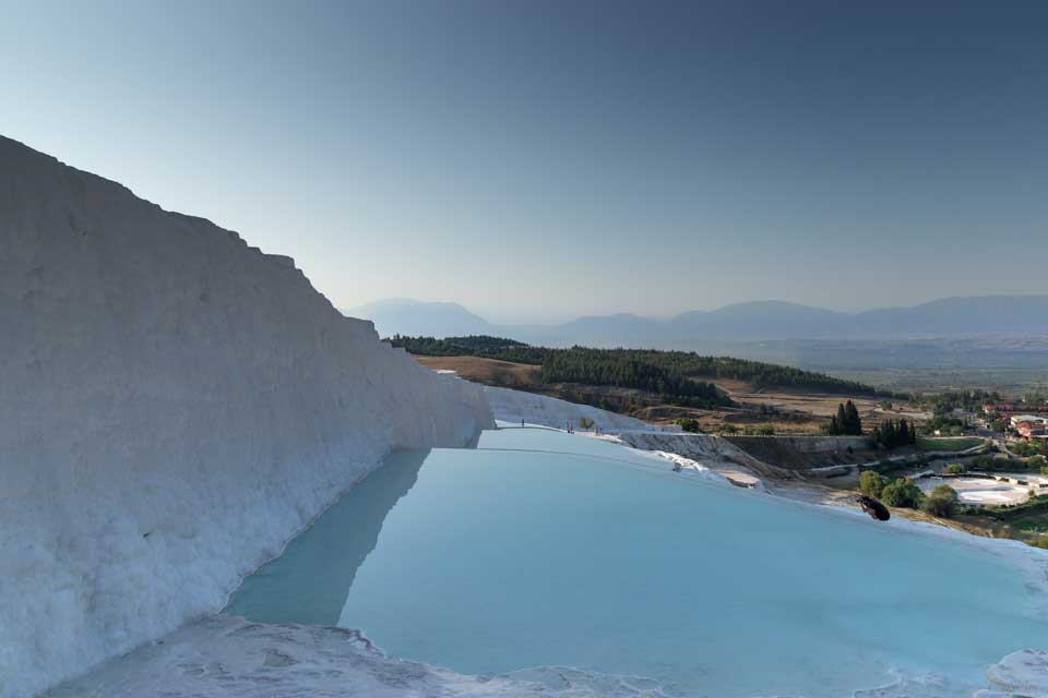 hot spring terraces with water and a view of Pamukkale