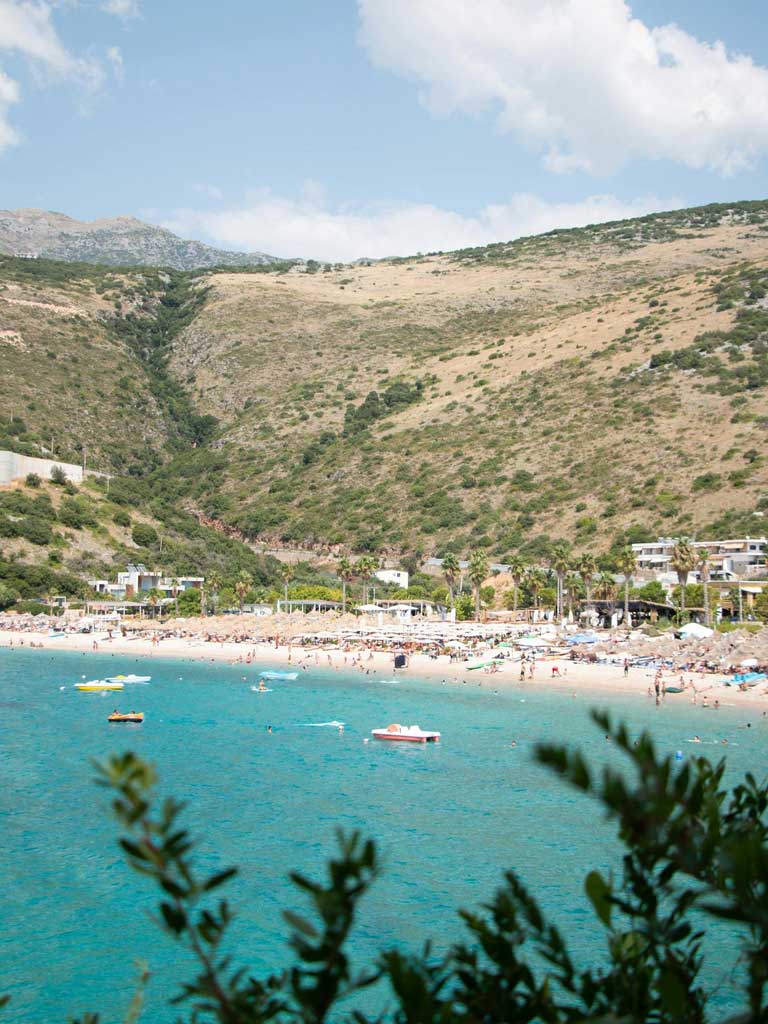 Jale resort Albania, Jale beach with umbrellas and people sunbathing
